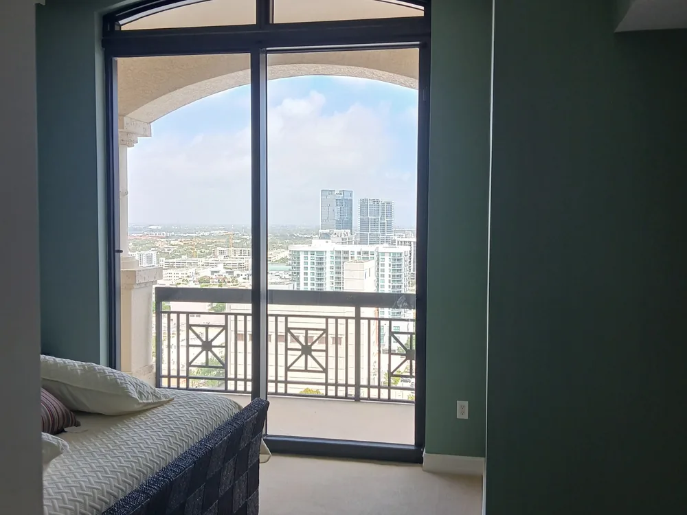 Freshly painted room with arched window and water view